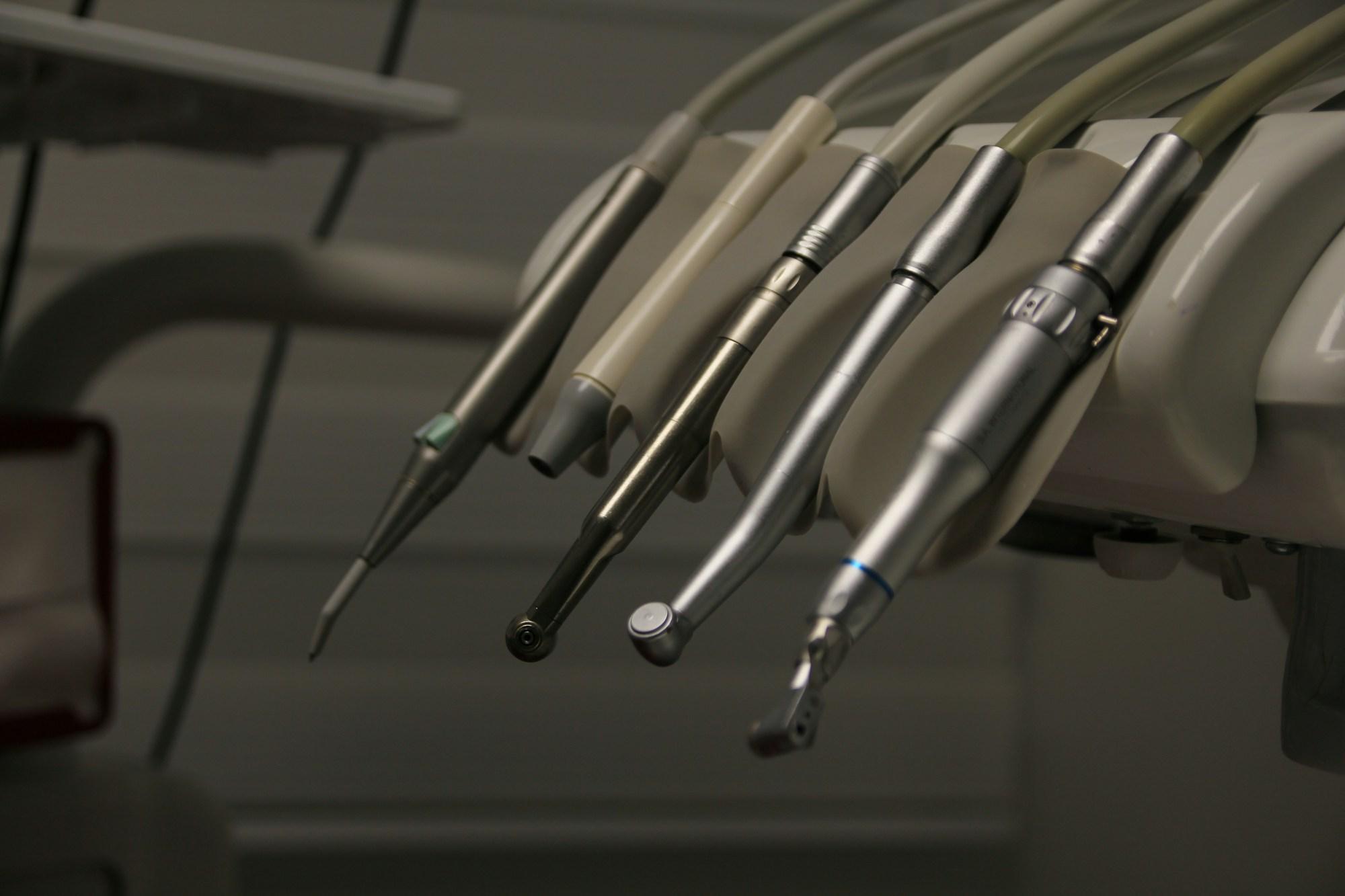 Dental handpieces resting in their holders on a treatment unit